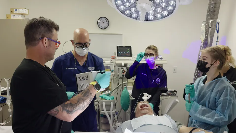 Dr. Lillis working through a case with a clinical team at chairside